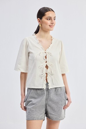 Relaxed Fit Top With Ruffles and Front-Ties in Cream from Reistor
